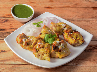 Assorted indian food Chicken reshmi kebab served on wooden background. Dishes and appetizers of indian cuisine, selective focus