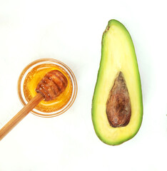Avocado and honey on a white background