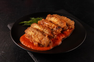 Buffolo wings close-up with tomato sauce and tomatoes