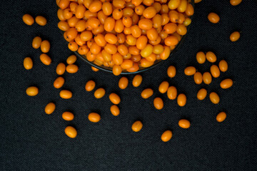 Sea buckthorn on a white background. Natural, organic sea buckthorn berries in a bowl