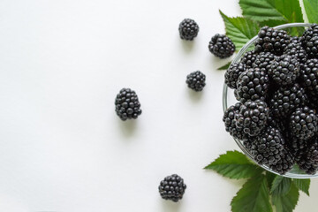 Fresh blackberry with green leaves isolated on white background. Ripe blackberry fruits with leaves.