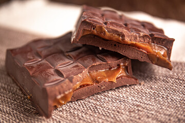 Broken assorted chocolate bar with caramel filling. Gluten free. Gourmet. Close up.