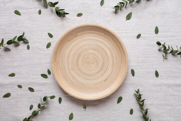 Wooden platy on table, empty plate, cosy home, scandinavian style concept, top view