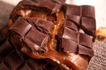 Broken assorted chocolate bar with caramel filling. Gluten free. Gourmet. Close up.