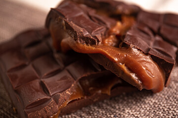 Broken assorted chocolate bar with caramel filling. Gluten free. Gourmet. Close up.