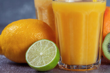 Close-up of fruits on the background of glasses with orange juice