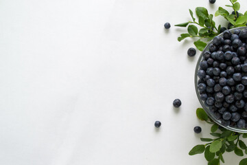 Fresh Blueberries in a bowl on white background. Juicy wild forest berries, bilberries. Healthy eating or nutrition.