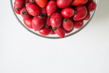 Rose-hips or wild rose berries isolated on a white background.
