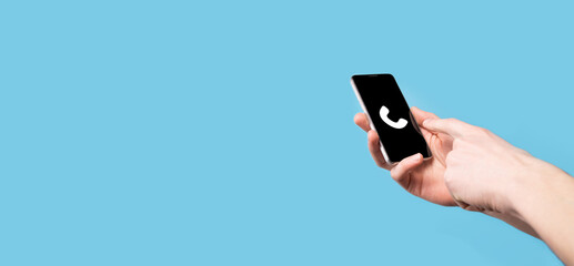 Male hand holding smart mobile phone with phone icon.Call Now Business Communication Support Center Customer Service Technology Concept.
