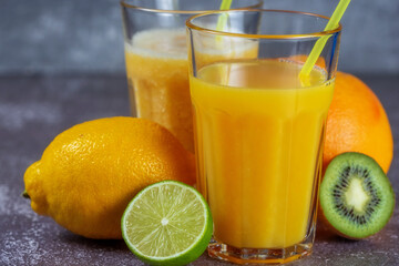 Freshly squeezed orange juice and banana and orange smoothies in tall glasses