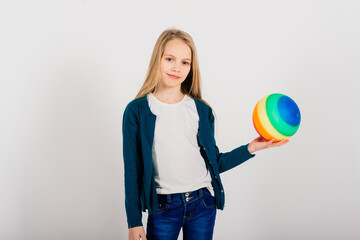 Beautiful girl holding coloured bright ball isolated on white