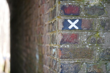 x cross as a route marker at the entrance to a pedestrian tunnel