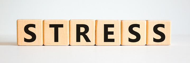 Stop stress and be health symbol. Wooden cubes with the word 'stress'. Beautiful white background. Psychological, business and stop stress concept. Copy space.