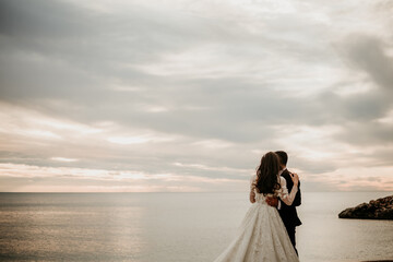 romantic wedding by the sea details hands rings sand sunset