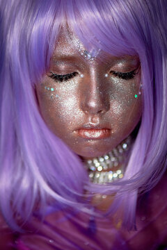 A Little Girl In A Purple Wig With Silver Sequins On Her Face. An Alien, Fantasy World.A Fairy Or An Alien. Eyes Closed. A Peaceful Face, Calm.