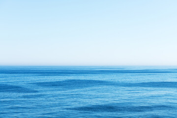 Ocean water and blue sky abstract background. Sea water texture closeup