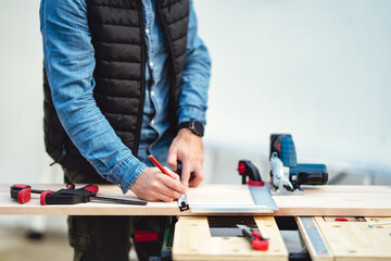 a man working with equipment on a wooden table in his backyard