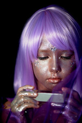 A girl with purple hair and glowing skin. An alien or a fairy with glowing skin.