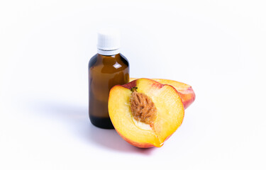 Fresh peach isolate with oil bottle on white background