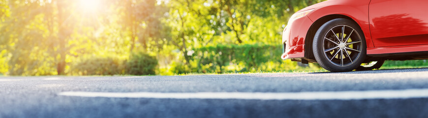 Red car on asphalt road on summer sunlight. © candy1812