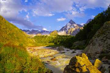 Fototapeta premium The Adyl River in a high mountain gorge in the Elbrus region