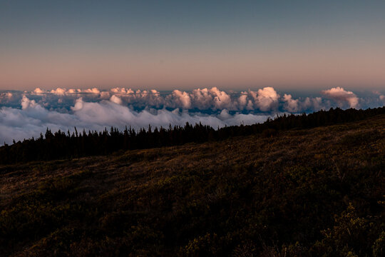 Clouds reflect the evening sun below the slopes of Haleakala in Maui, Hawaii
