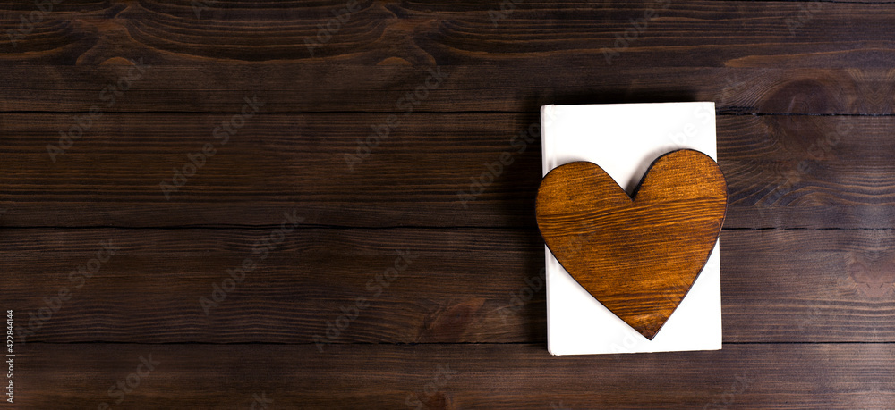 Wall mural opened holy bible books on the table. scripture. heart on the book. on a wooden background