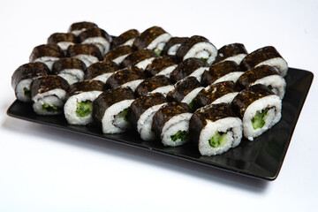 Fresh delicious japanese sushi with avocado on white background.