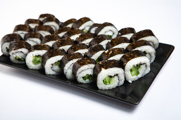 Fresh delicious japanese sushi with avocado on white background.