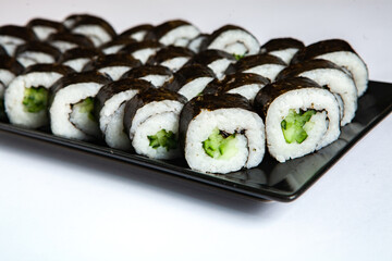 Fresh delicious japanese sushi with avocado on white background.