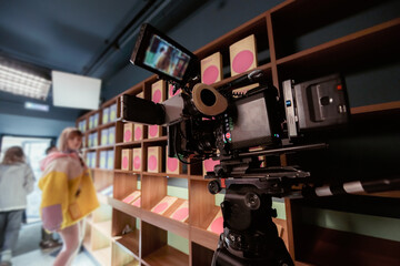 Professional film and video camera on the set. Shooting shift, equipment and group. Modern...