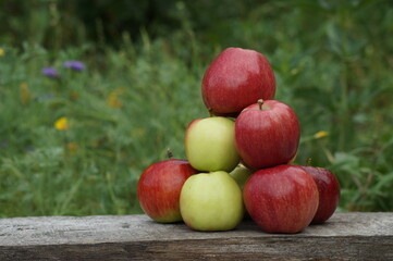 A harvest of ripe red and green apples has been collected.