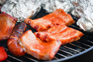 Grilling meat and sausages on a bbq