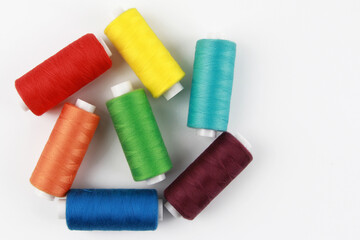 Colored, rainbow threads for sewing with a needle. Handmade concept, clothing repair. Top view. Flatlay. Copyspace.