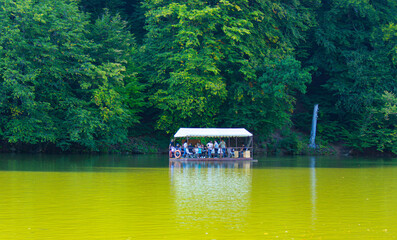 Parz Lich (Clear Lake) in Dilijan, Armenia.tourists traveling by boat.