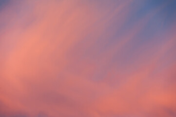 An abstraction from a piece of blurred sky in pink and orange tones