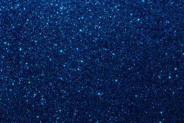 Blue glitter foil Christmas background. Shiny metal blue foil texture abstract defocused background. Sparkle glitter texture with bokeh lights