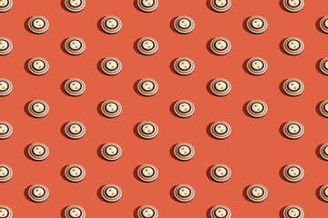 Old button pattern with one missing on a red background. Retro colors, creative vintage flat lay.