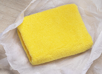 yellow bamboo towel on delicate white paper. Spa Gift Idea 