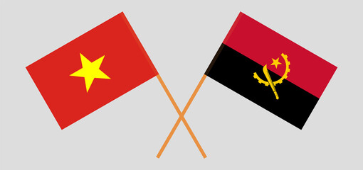 Crossed flags of Vietnam and Angola. Official colors. Correct proportion
