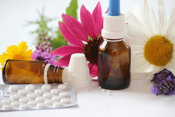 Bottles, globulis with lavender and sun hat/background for naturopathy and homeopathy