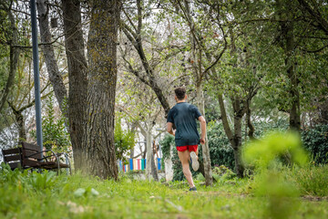 Obraz premium Unrecognized male runner with sportswear working out in the park.