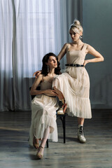 Studio portrait blondes and brunettes, looking at camera. The girls look in different directions.