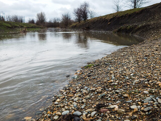 river in spring, a lot of  water, rocky shore