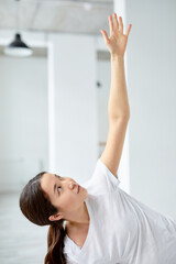 Beautiful Pregnant Woman Doing Yoga In Studio, Raising Hands