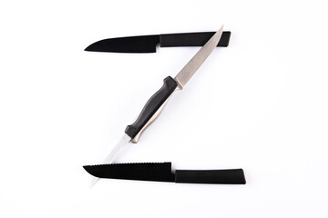 Alphabet made of knives isolated on white background. Letter 