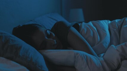 Trouble sleeping. Night insomnia. Bedtime fatigue. Disturbed tired woman lying in bed with closed eyes late in dark home bedroom with blue light. - Powered by Adobe