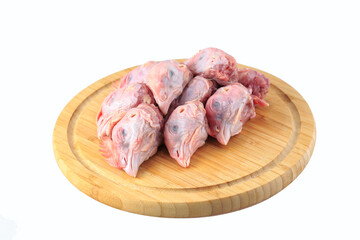 raw chicken heads on a white background