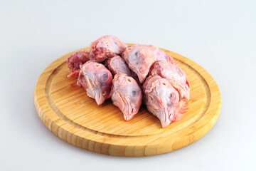 raw chicken heads on a white background