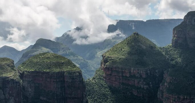 Clouds drifting over green mountains. Three Rondavels at Blyde river canyon